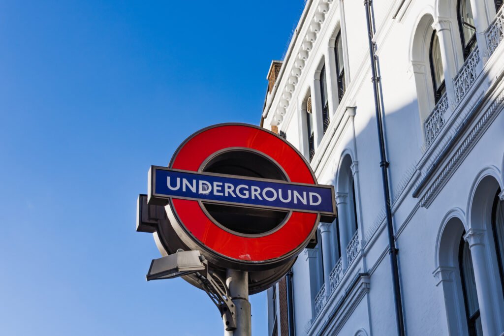subway entrance sign for london underground near historic white building